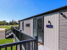An outdoor view of a cabin entrance at Lakewood Plot 9 St. Osyth