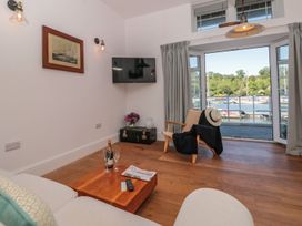 A living room with a sofa and armchair at Shipwrights in Brixham