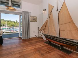 A room with a sailing boat model and a view of the marina at Shipwrights Brixham