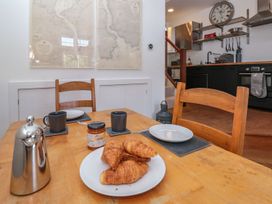 A dining room with a table set for breakfast at Shipwrights in Brixham