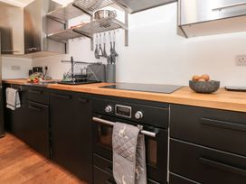 A kitchen with appliances and wooden countertop at Shipwrights Brixham