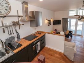 A kitchen with a sink and stove at Shipwrights in Brixham