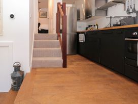 A kitchen with a staircase and appliances at Shipwrights in Brixham
