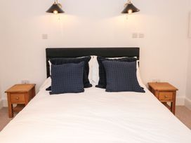 A bedroom with a bed and bedside tables at Shipwrights in Brixham
