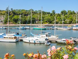 Boats at a dock with flowers in the foreground at Shipwrights Brixham