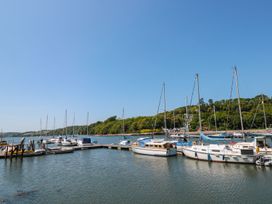 A view of boats at a dock surrounded by trees at Shipwrights in Brixham