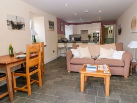A living room with a sofa and dining area at Spanish Boathouse in Brixham