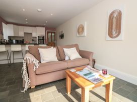 A living room with a sofa and coffee table at Spanish Boathouse in Brixham