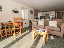 A living room with a sofa and dining table at Spanish Boathouse in Brixham