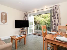 A living room with a television and dining area at Spanish Boathouse in Brixham