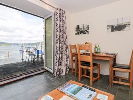 A dining room with a table and chairs at Spanish Boathouse in Brixham