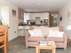 A living room with a sofa and dining area at Spanish Boathouse in Brixham