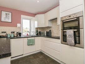 A kitchen with modern appliances at Spanish Boathouse in Brixham