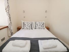 A bedroom with a bed and pillows at Spanish Boathouse in Brixham