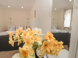 A bedroom with a bed and flowers in a vase at Spanish Boathouse in Brixham