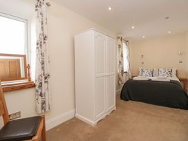 A bedroom with a bed and wardrobe at Spanish Boathouse in Brixham
