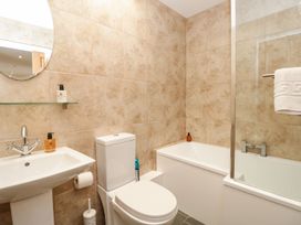 A bathroom with a sink, toilet, and bathtub at Spanish Boathouse in Brixham