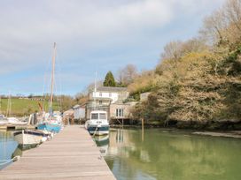 A view of boats at a pier near a building at Spanish Boathouse in Brixham