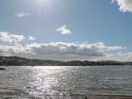 A view of water with boats and hills in the background at Spanish Boathouse in Brixham