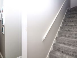 A staircase leading upstairs in the hallway at 12 Courtyard Cottage at Sheplegh Court in Totnes