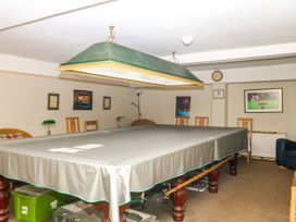 A snug with a billiard table and chairs at 12 Courtyard Cottage at Sheplegh Court Totnes