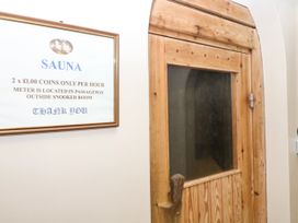 A sauna door near a sign indicating usage instructions at 12 Courtyard Cottage at Sheplegh Court in Totnes