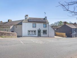 A house featuring solar panels and windows at The Quirky Cottage near Eamont Bridge