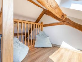 A loft area with bean bags and wood beams at The Quirky Cottage Eamont Bridge near Ullswater