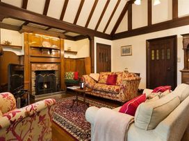 A living room with a fireplace and seating at White Gables in Ambleside