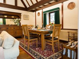 A dining room with a wooden table and chairs at White Gables in Ambleside