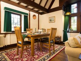 A dining room with a table set for a meal at White Gables in Ambleside