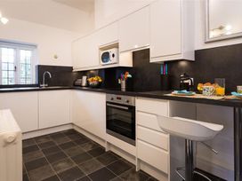 A kitchen with modern appliances and a window at White Gables Ambleside
