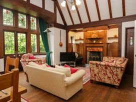 A living room with sofas and a fireplace at White Gables in Grasmere