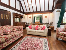 A living room with sofas and a dining table at White Gables in Grasmere