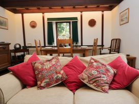 A living room with a sofa and dining table at White Gables in Grasmere
