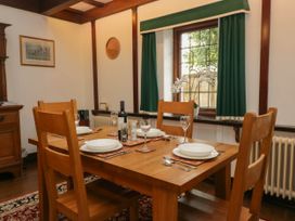 A dining room with a wooden table set at White Gables in Grasmere