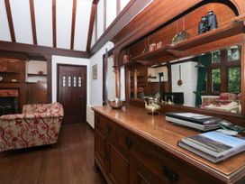 A living room with a sofa and cabinet at White Gables in Grasmere