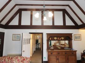 A living room with a sideboard and light fixture at White Gables in Grasmere