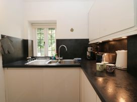 A kitchen with a sink, coffee maker, and toaster at White Gables in Grasmere