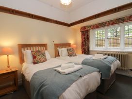 A bedroom with two beds and a window at White Gables in Grasmere
