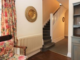 A hallway with stairs and a radiator at White Gables in Grasmere