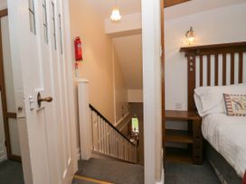 A staircase with a door and bedroom furniture at White Gables in Grasmere
