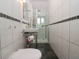 A bathroom with a toilet, sink, and shower at White Gables in Grasmere