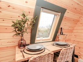 A dining area with a wooden table and chairs at Windy Ridge Lodge in Egton