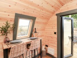 A dining area with a table and chairs at Windy Ridge Lodge in Egton