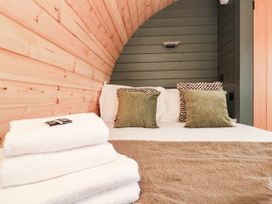 A bedroom with a bed and pillows at Windy Ridge Lodge in Egton