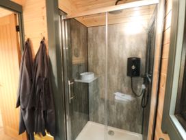 A shower area with towels and robes at Windy Ridge Lodge in Egton