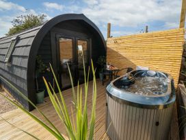An outdoor area with a hot tub and seating at Windy Ridge Lodge in Egton