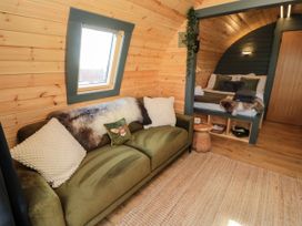 A bedroom with a bed and sofa at Windy Ridge Lodge Egton