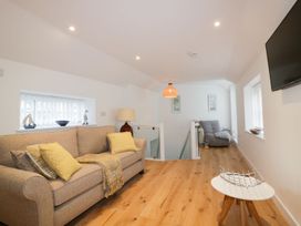 A living room with a sofa and coffee table at Fishermans Loft in Mevagissey